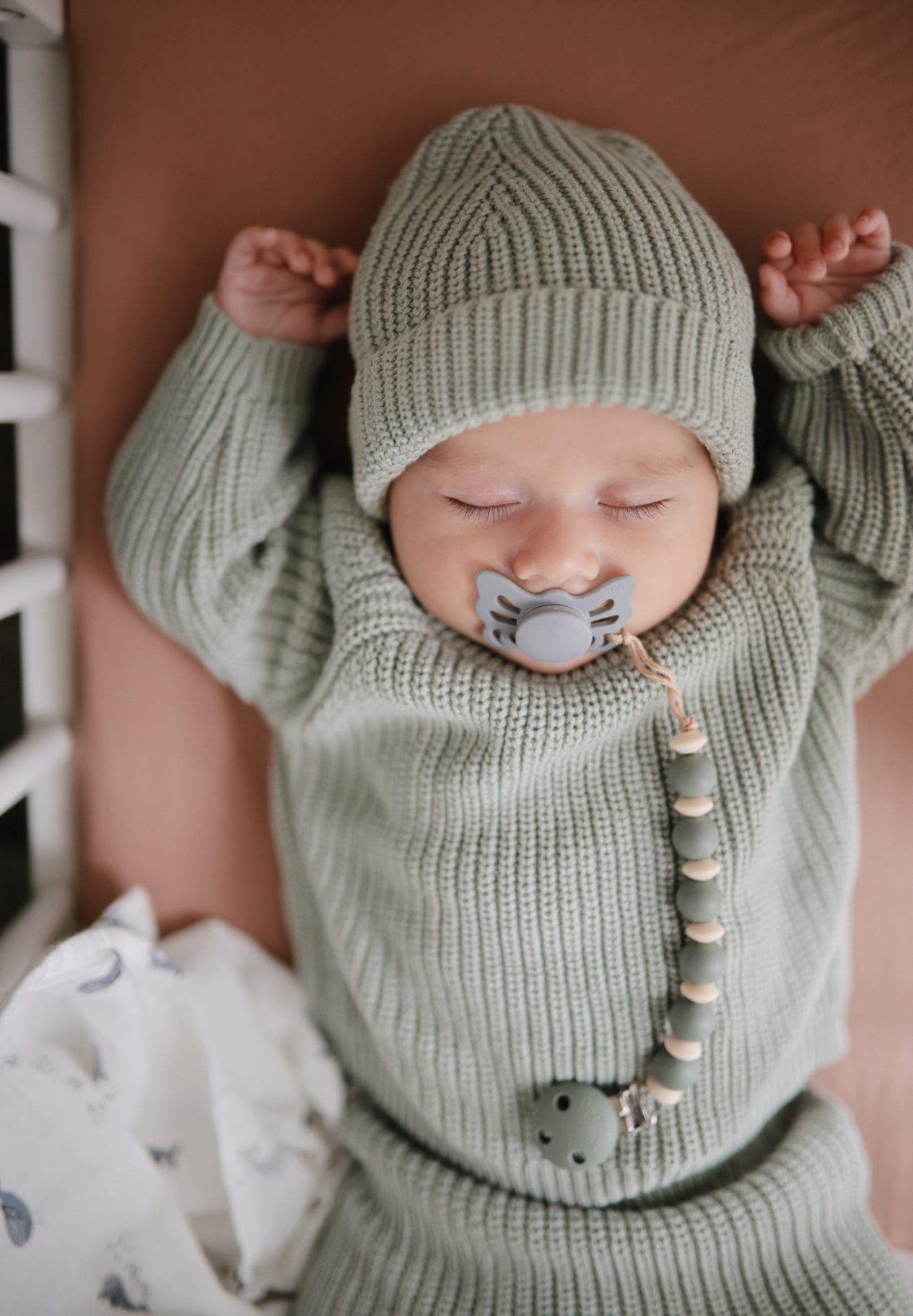 Sleeping baby with pacifier and clip