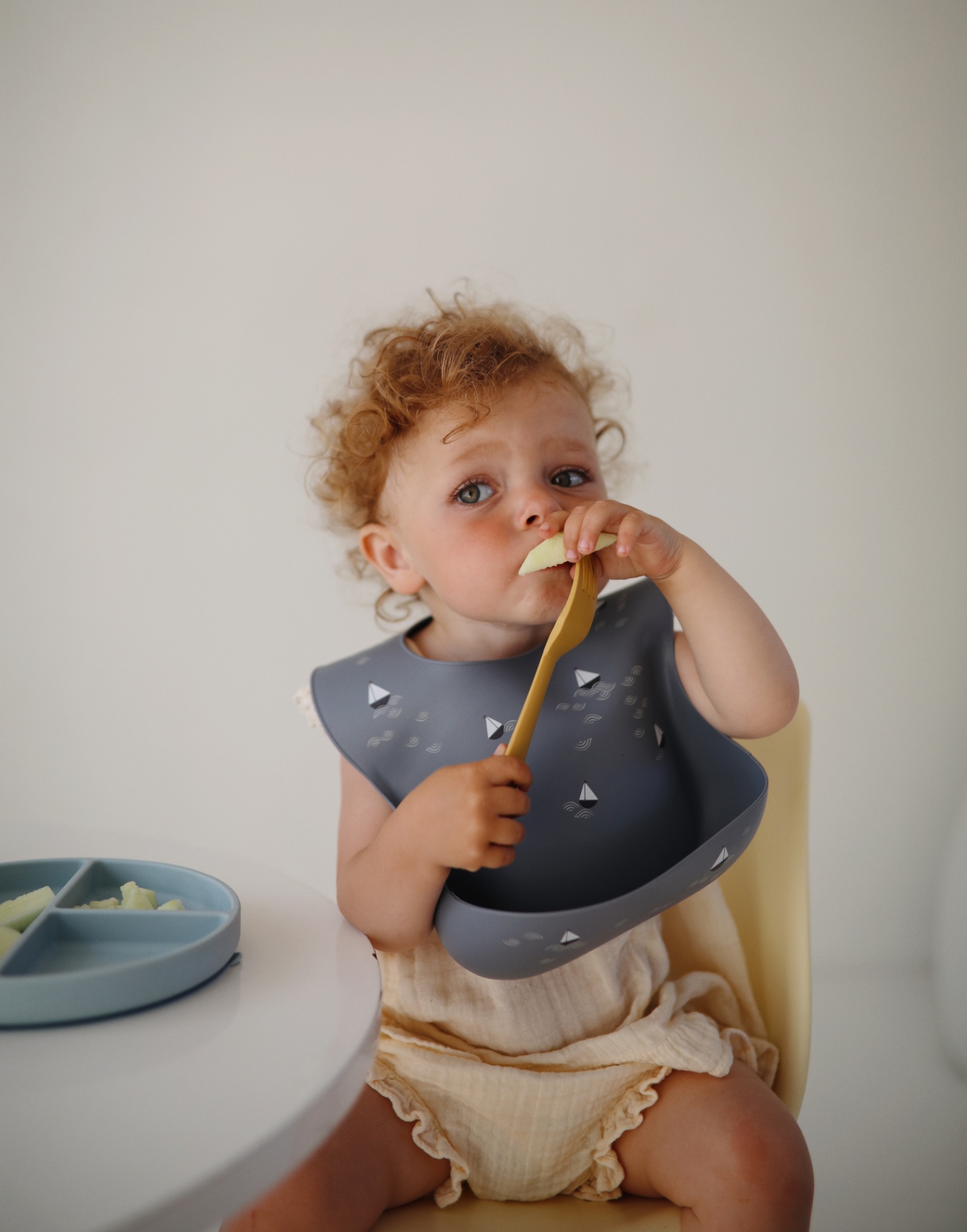 Baby eating with a silicone bib